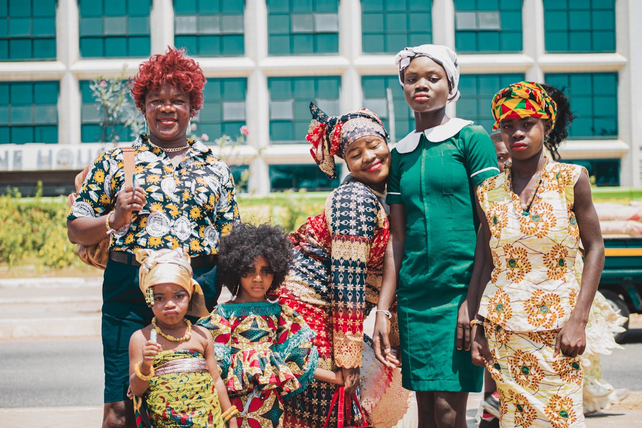 Colorful group portrait showcasing vibrant African fashion with traditional patterns in Accra, Ghana.